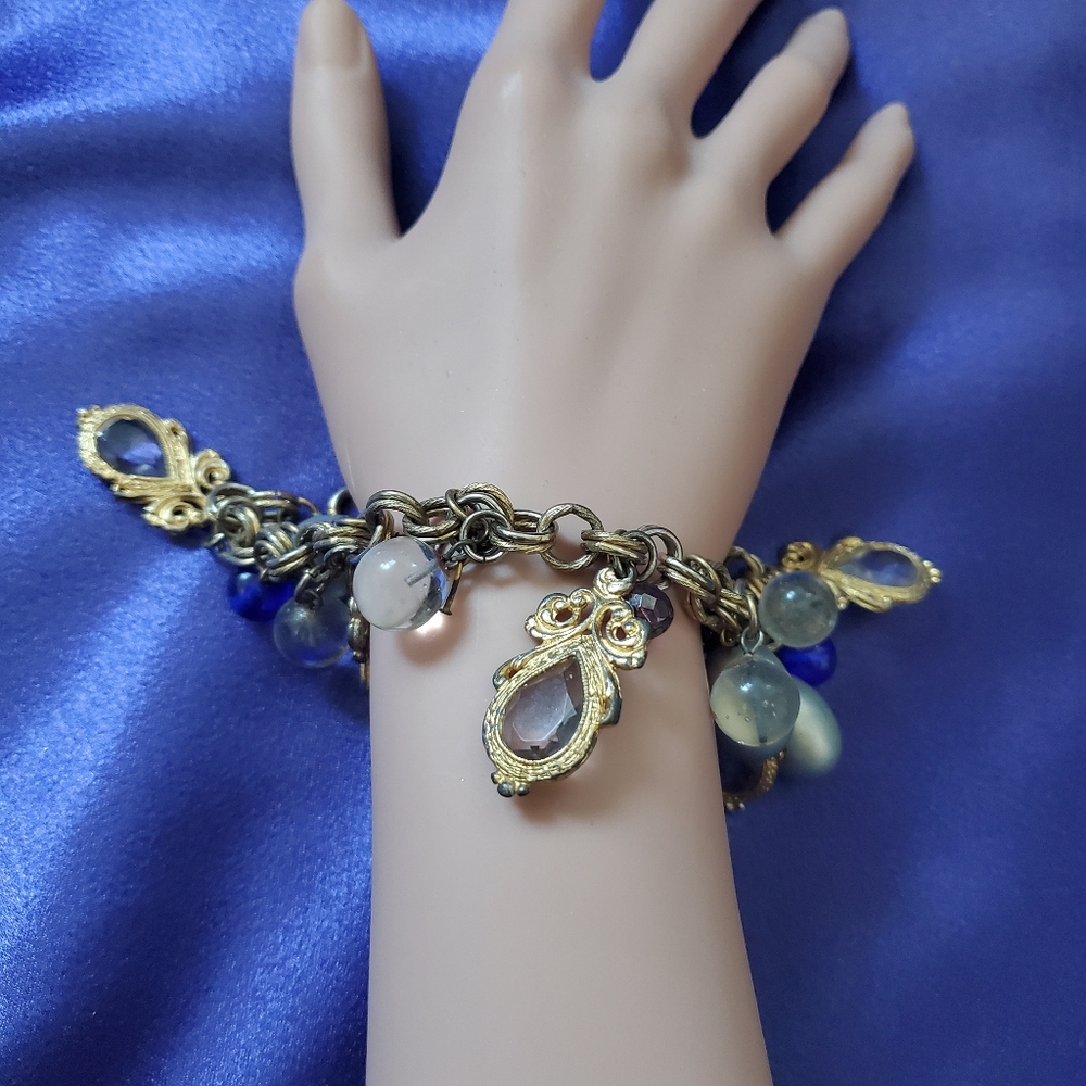 Vintage women's charm bracelet.  Brass chain with beads, gold trinkets
